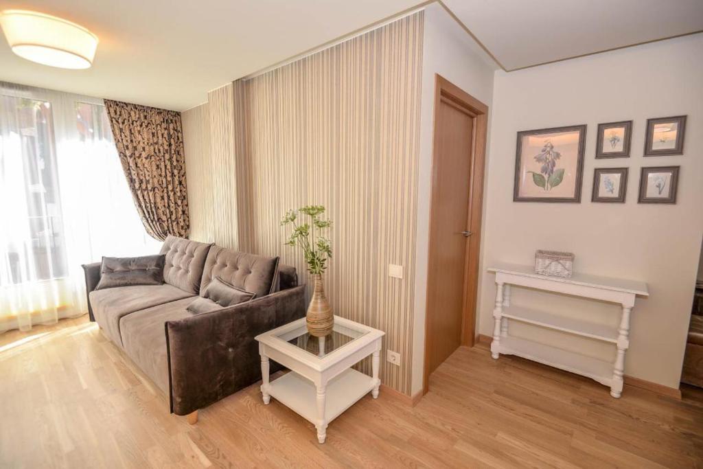 a living room with a couch and a table at IN24 in Palanga