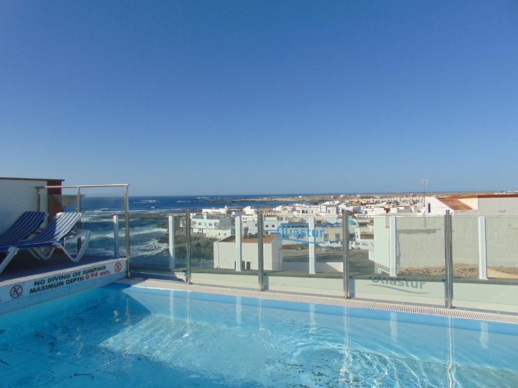 a swimming pool with a view of a city at Be Cotillo Apartment in El Cotillo