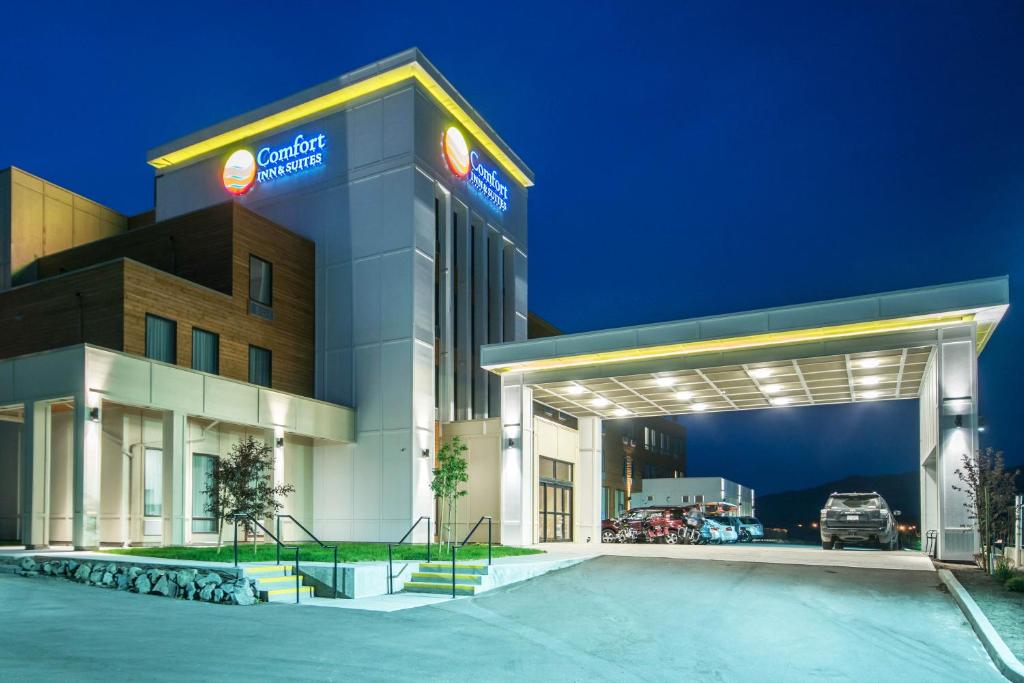 a hotel with a car garage at night at Comfort Inn & Suites Merritt in Merritt