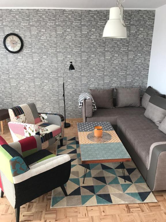 a living room with a couch and a table at Apartament Rona in Stronie Śląskie