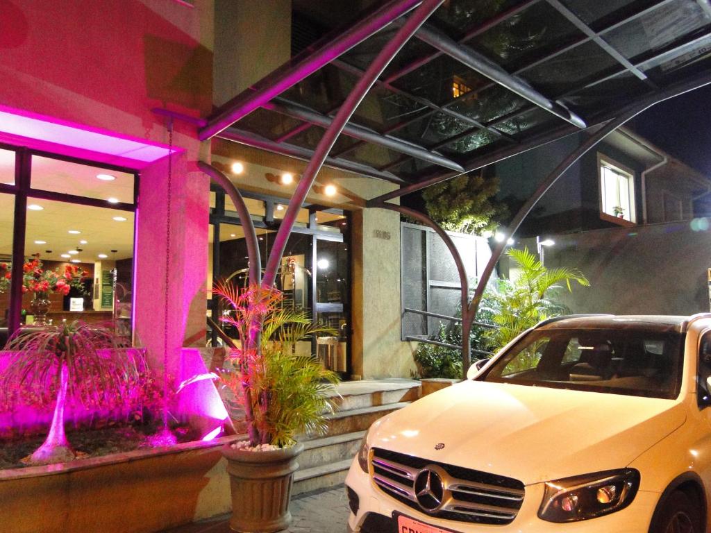 a white car parked in front of a building at Premium Flats Berrini in São Paulo