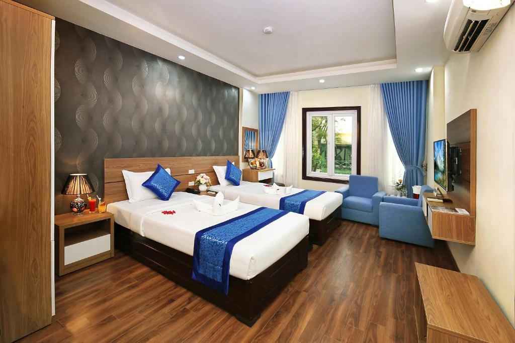 Postel nebo postele na pokoji v ubytování Aquarius Grand Hotel