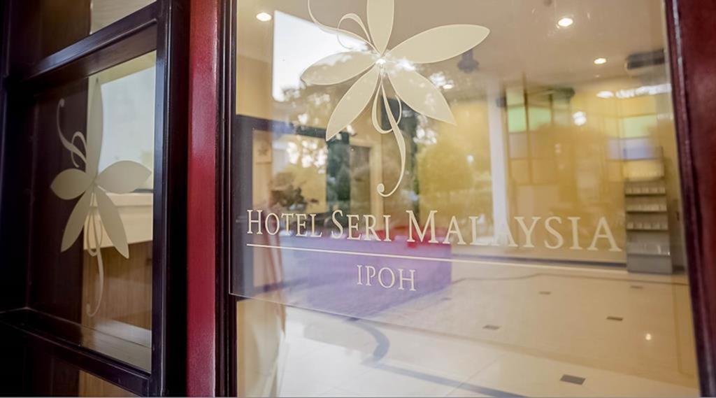 a store window with a flower sign on it at Hotel Seri Malaysia Ipoh in Ipoh