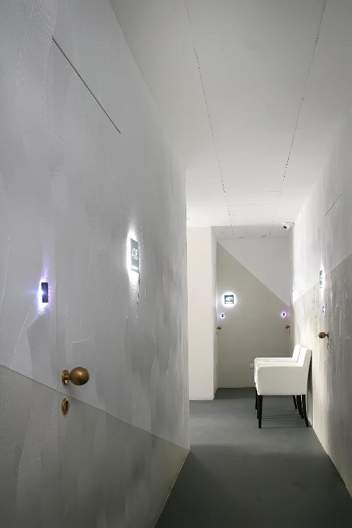 a white room with a white couch and a chair at Residence Terminus in Rimini
