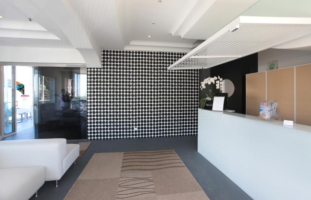a living room with a black and white tiled wall at Residence Terminus in Rimini