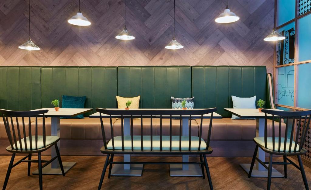 a restaurant with two tables and two chairs at Leonardo Hotel Manchester Central in Manchester