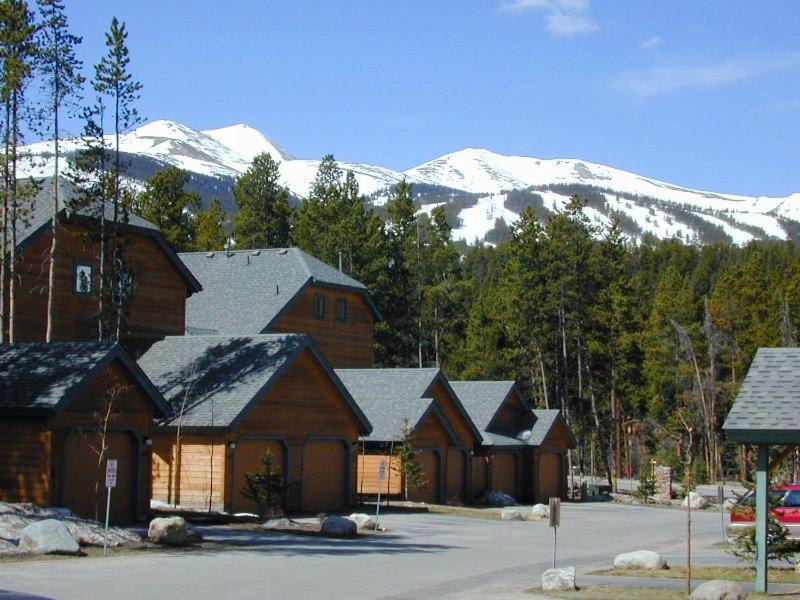 a group of buildings with snow covered mountains in the background at Village Point 101 in Breckenridge