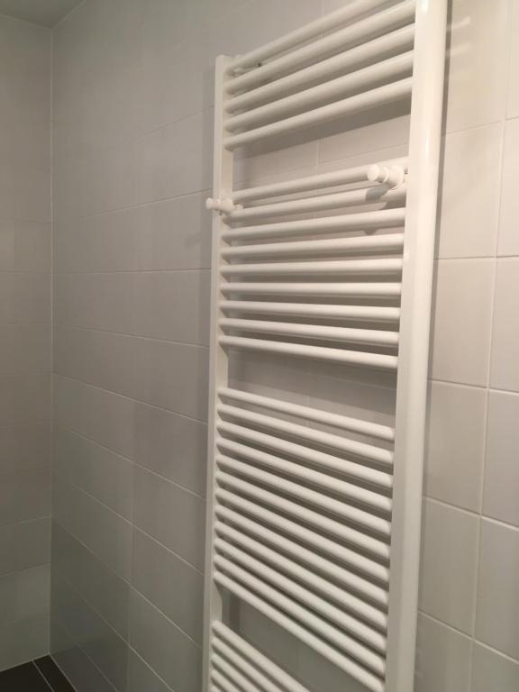 a white towel rack in a shower in a bathroom at AAA Fewo Bad Kleinkirchheim in Bad Kleinkirchheim