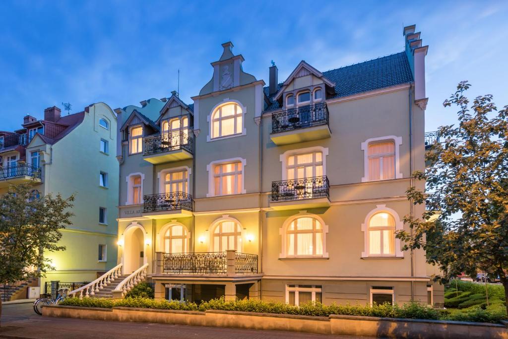 a large yellow building with windows and balconies at Apartamenty Villa Artis in Świnoujście