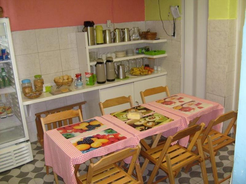 una cocina con mesa y sillas con comida. en Hostel Flamengo, en Río de Janeiro