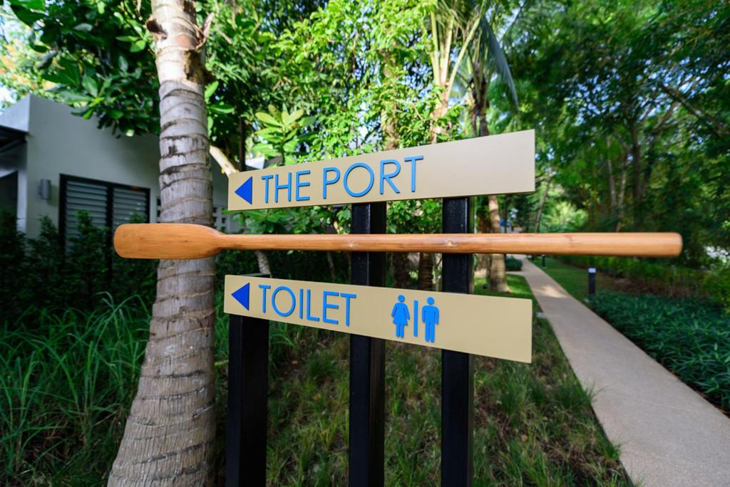 a sign that says the port and a hotel at Deevana Krabi Resort in Ao Nang Beach
