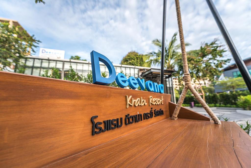 a sign on the side of a wooden boat at Deevana Krabi Resort in Ao Nang Beach