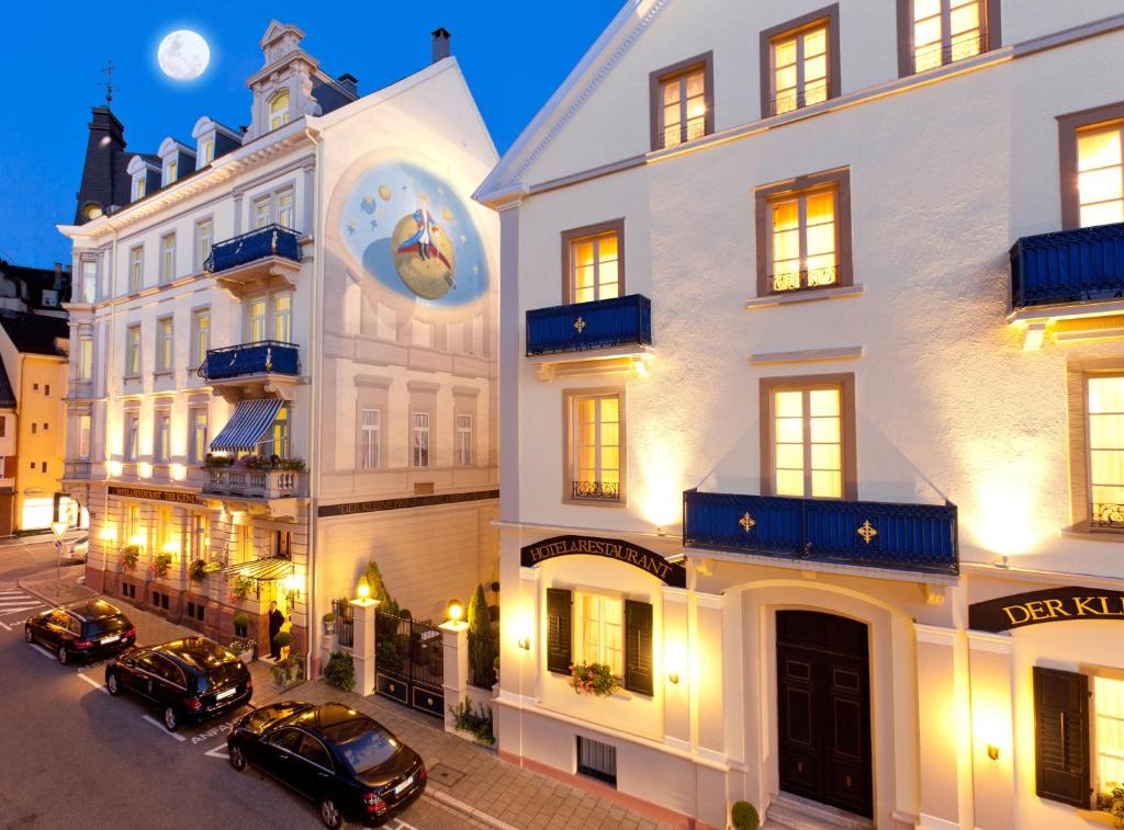 a group of buildings with cars parked in the street at Hotel Der Kleine Prinz in Baden-Baden