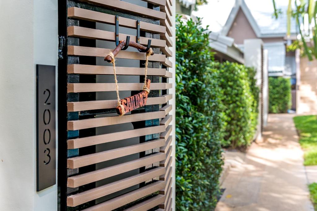 a wooden fence with a sign on the side of a house at Deevana Krabi Resort in Ao Nang Beach