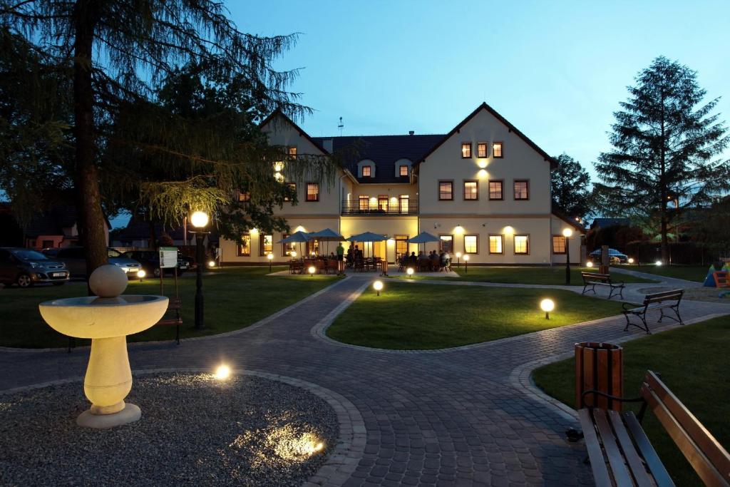 a large building with lights in front of it at Hotel Modrzewiowy Dwór in Gliwice