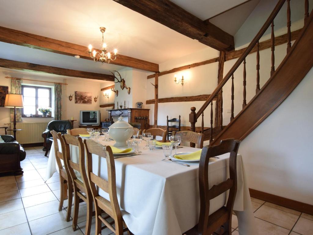 a dining room with a white table and chairs at Authentic Cottage in Weris with Private Garden in Weris