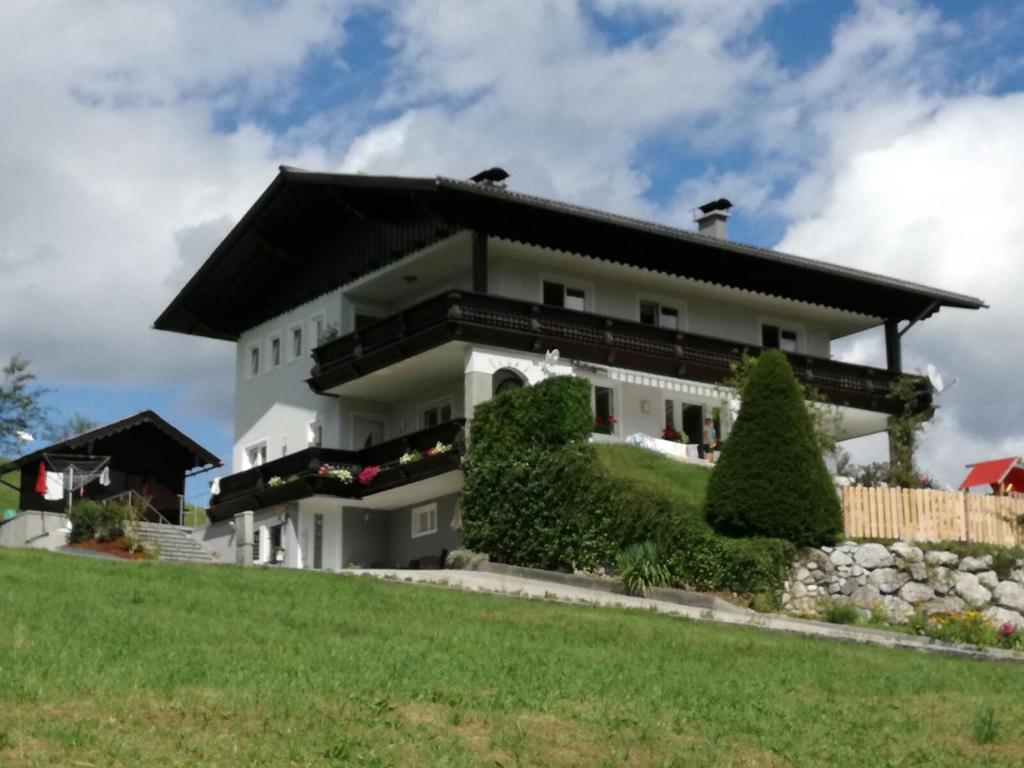 a large white house with a black roof at Haus Haslauer in Strobl