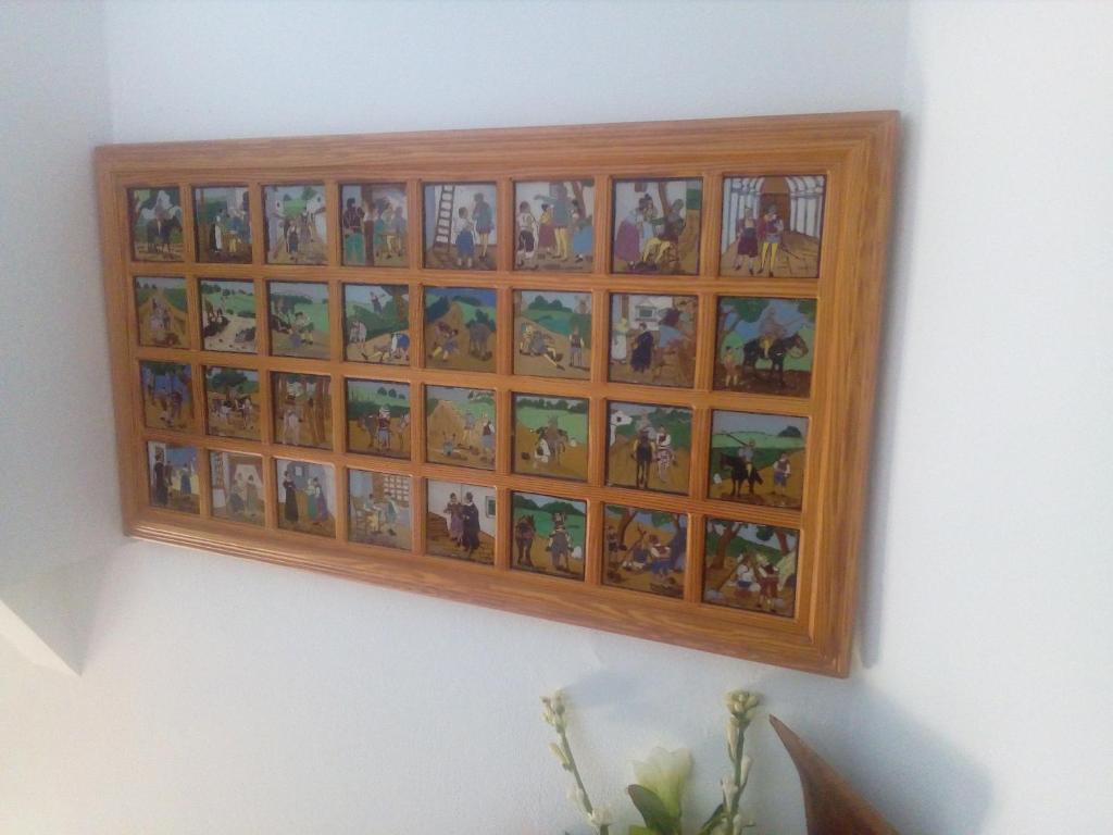 a wooden picture frame hanging on a wall at Hotel Restaurante Calderon in Arcos de la Frontera