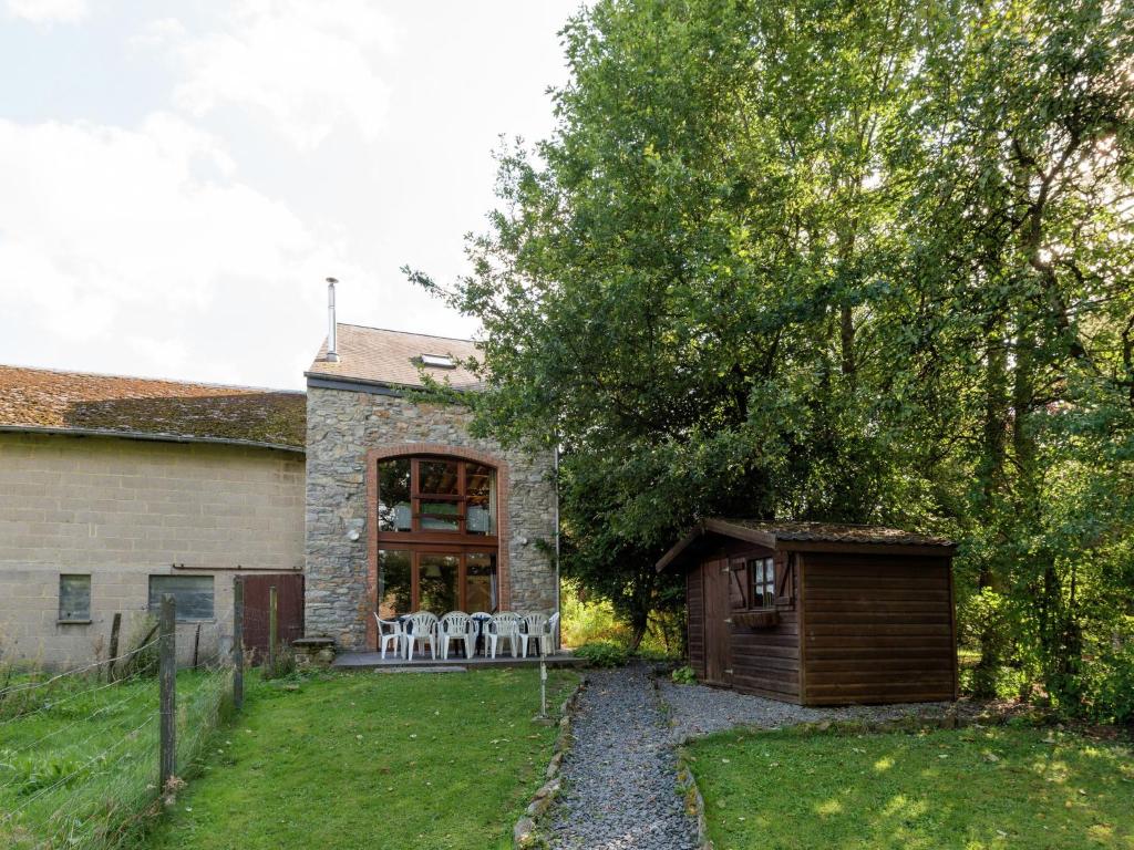a house with a garden and a table and chairs at Spacious holiday home in Vielsalm with garden in Vielsalm