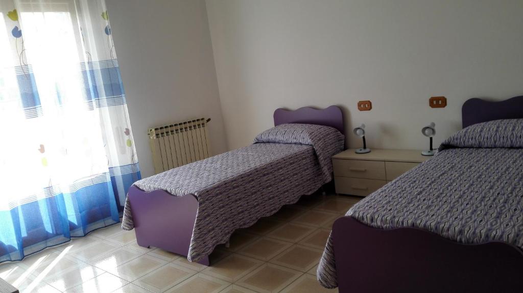 a bedroom with two beds and a window at Estia in Salemi