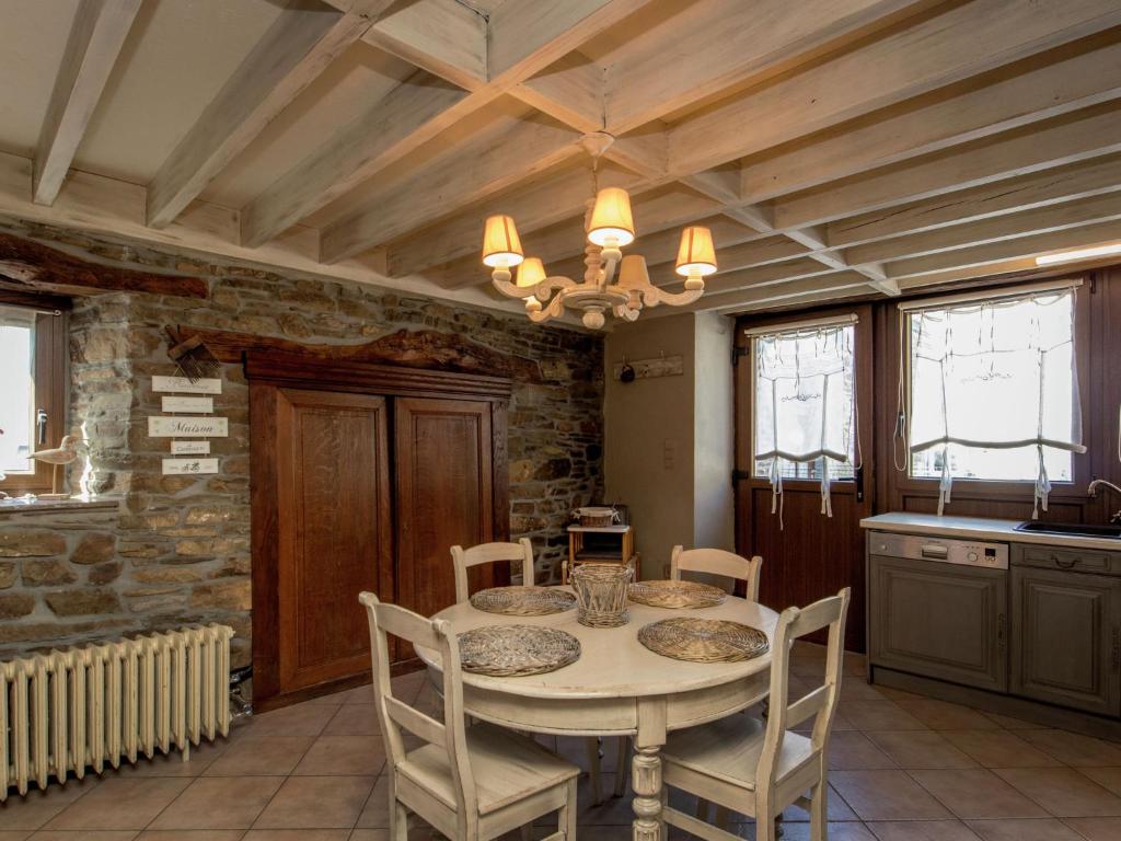 a kitchen with a table and chairs in a room at Beautiful Cottage in Malempre with Fenced Garden in Manhay