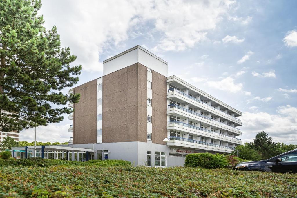 a largeartment building with a building at Hotel Plöner See by Tulip Inn in Plön