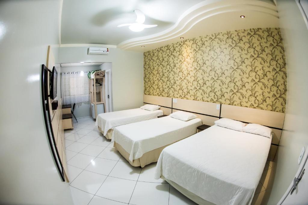 Postel nebo postele na pokoji v ubytování Hotel Tito's