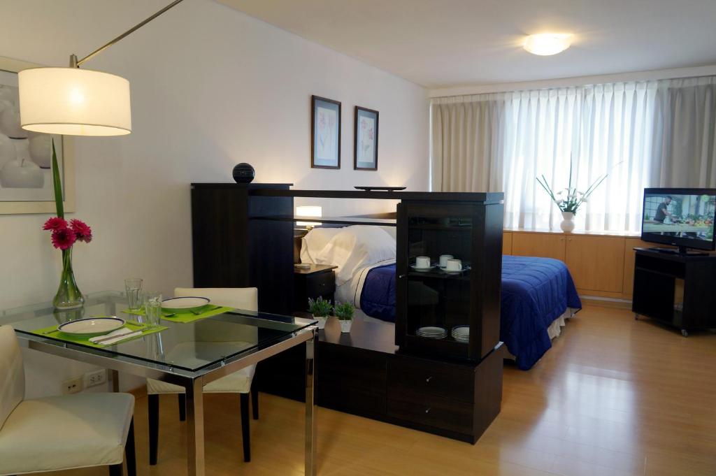 a hotel room with a bed and a desk and a room at Concord Callao by Recoleta Apartments in Buenos Aires