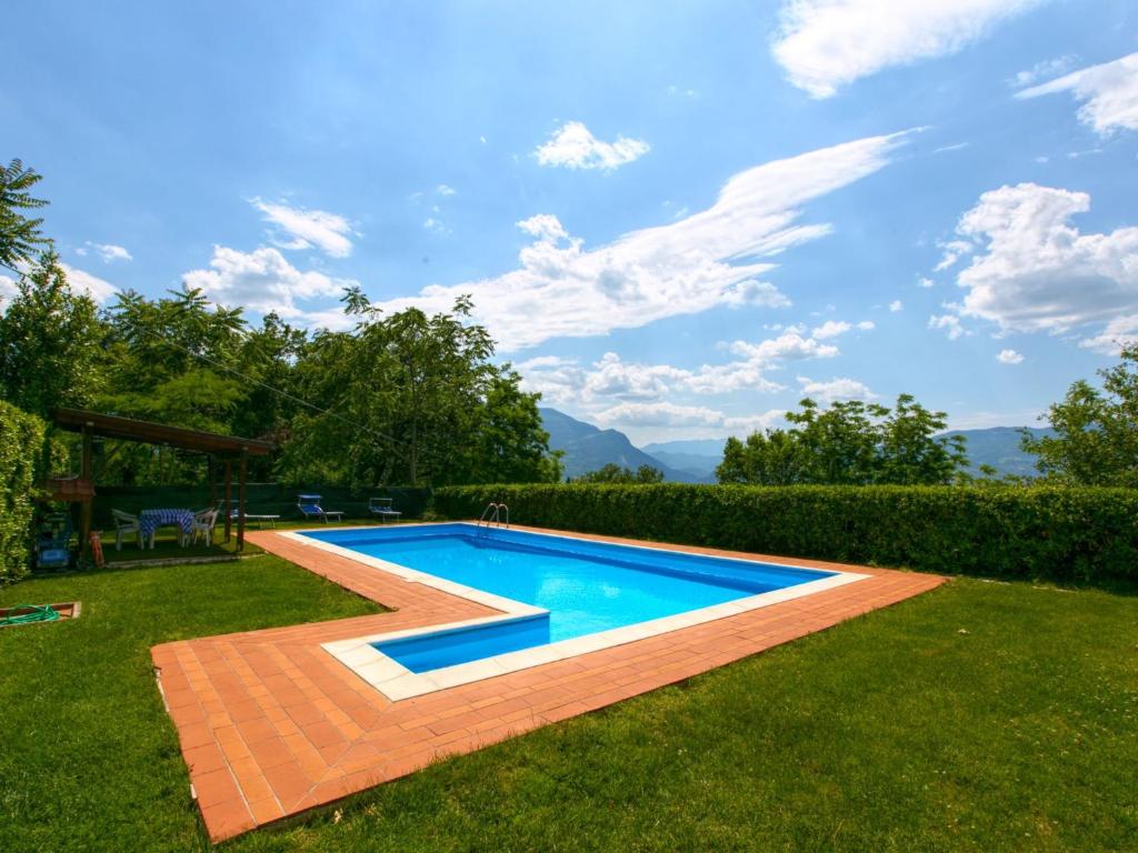 a swimming pool in the middle of a yard at Belvilla by OYO Villa Insieme in San Valentino in Abruzzo Citeriore