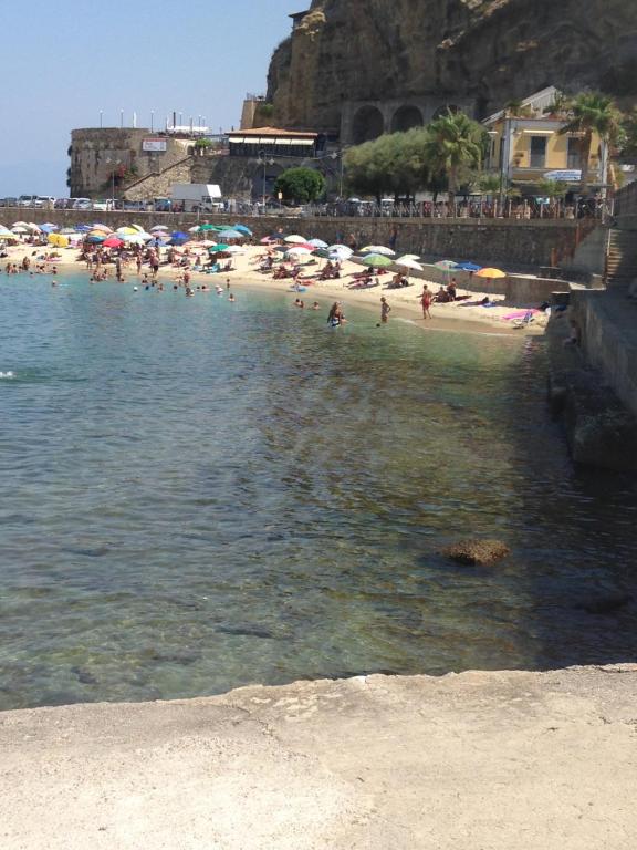 a group of people on a beach with umbrellas at Casa Vacanze Silvia in Pizzo