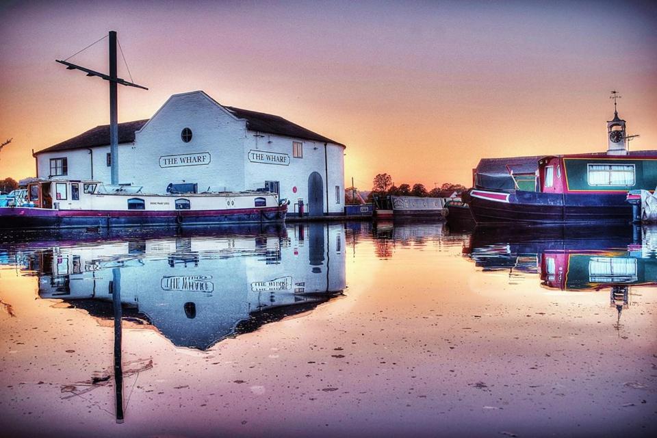 a house and a boat in a body of water at The Wharf Stourport in Stourport
