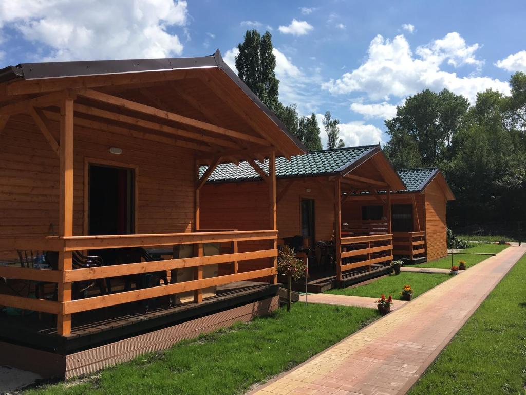 eine große Holzhütte mit einem Zaun um sie herum in der Unterkunft Ośrodek Słonecznik in Hel