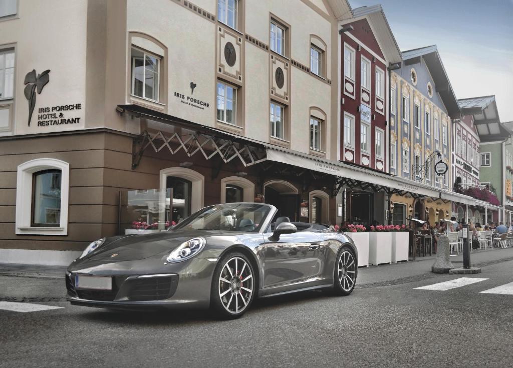 
a car parked on the side of a street at Iris Porsche Hotel & Restaurant in Mondsee
