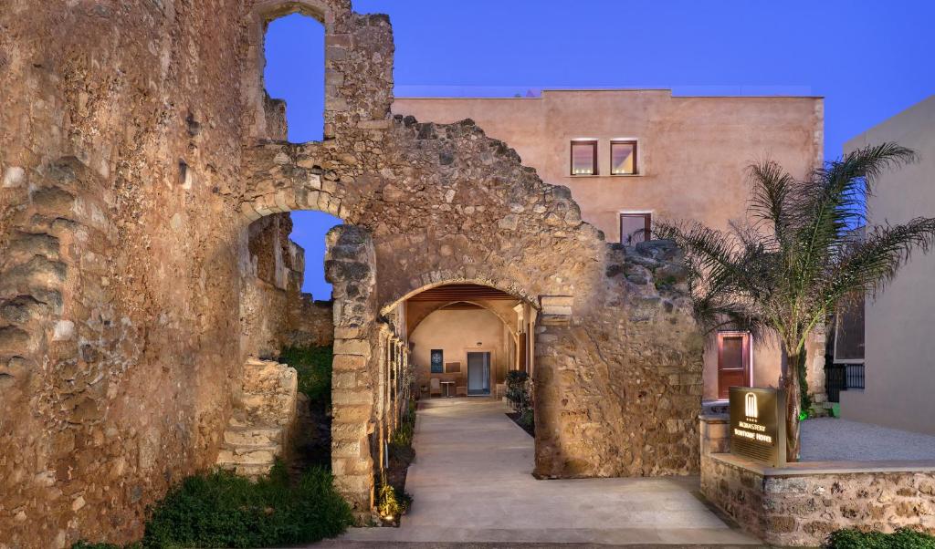 an entrance to a building with a stone wall at Madonna del Mare in Chania