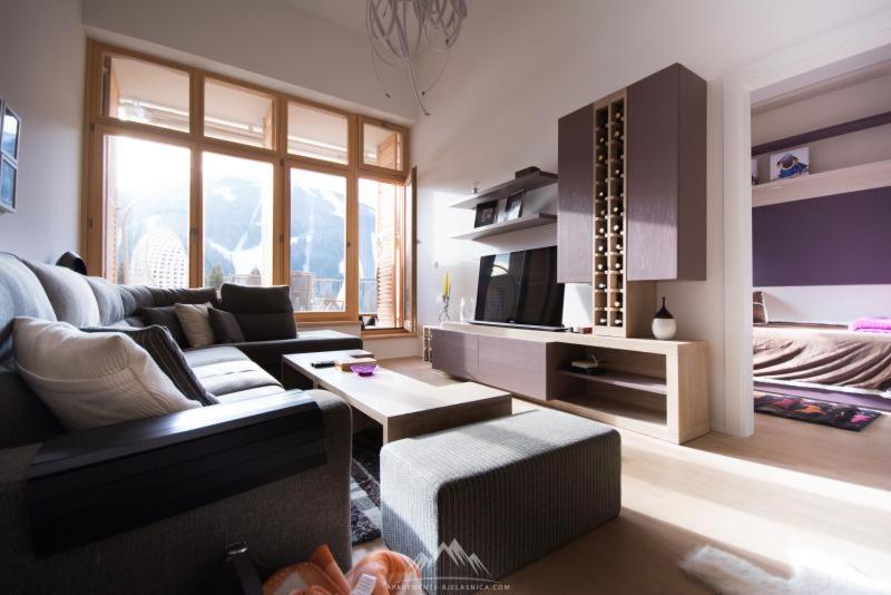 a living room with a couch and a tv at Engadin's 2BDR Apartment The View in Bjelašnica