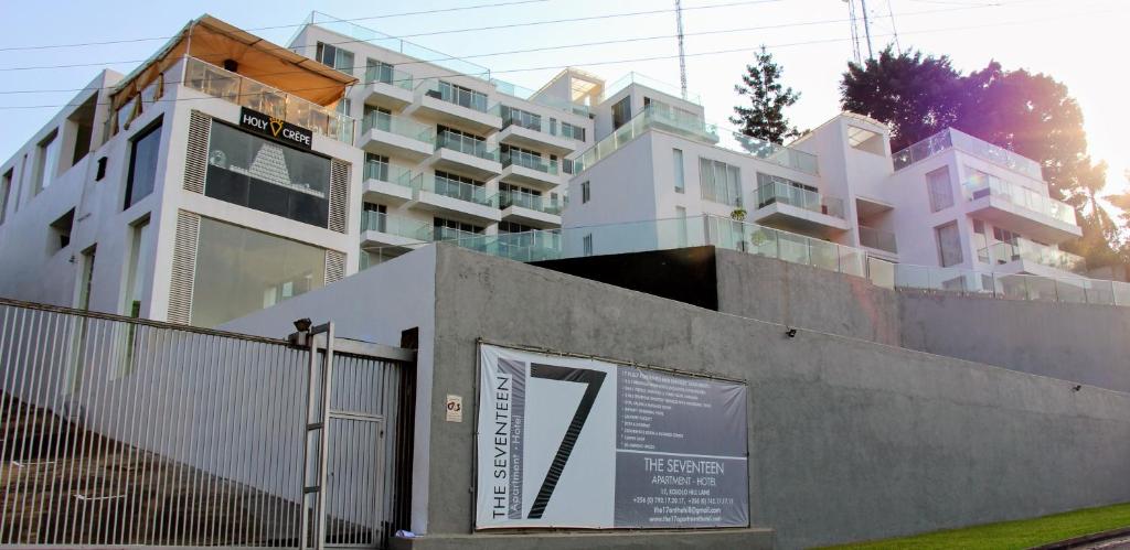 a building with a sign in front of it at The Seventeen Apartment Hotel in Kampala