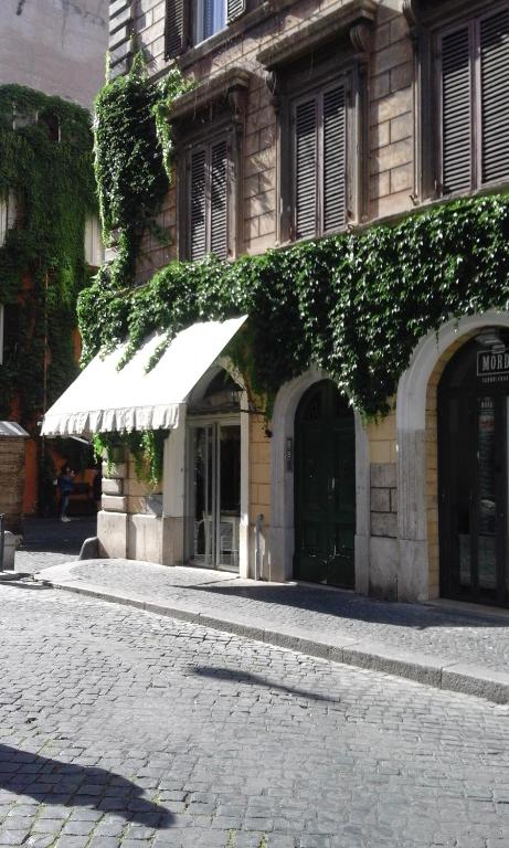 a building with a white awning on a street at appartamento " il piccolo ' in Rome