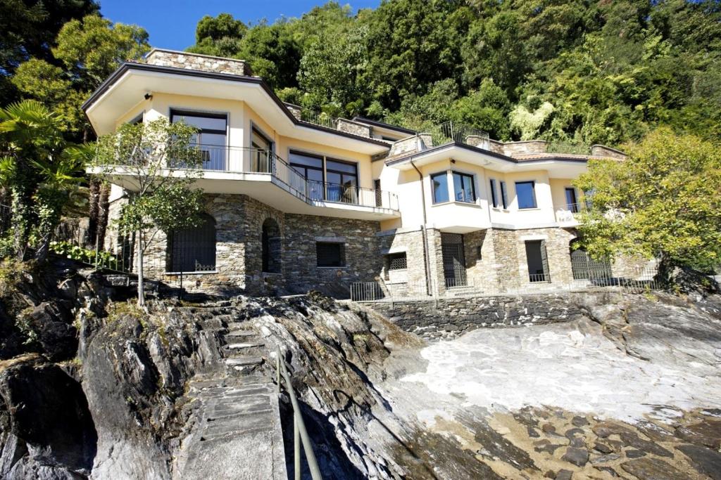 a house on top of a rocky hill at Villa Camelia in Verbania