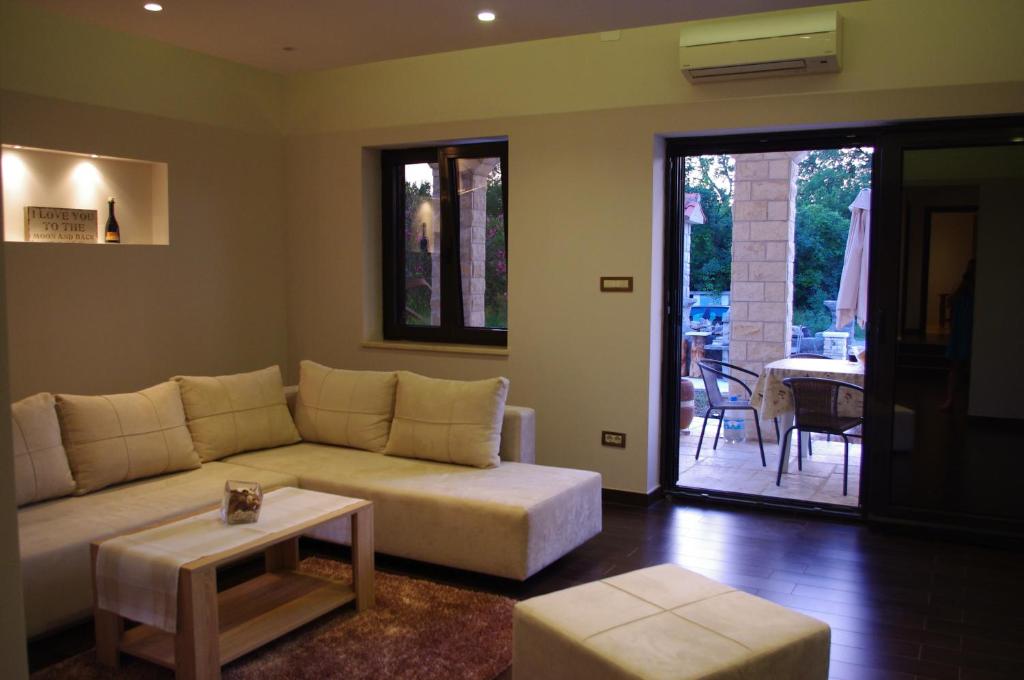 a living room with a couch and a table at Apartment Verano in Njivice