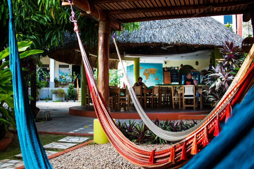 a hammock in a resort with a restaurant at Casa Losodeli & Coworking- Adults Only in Puerto Escondido