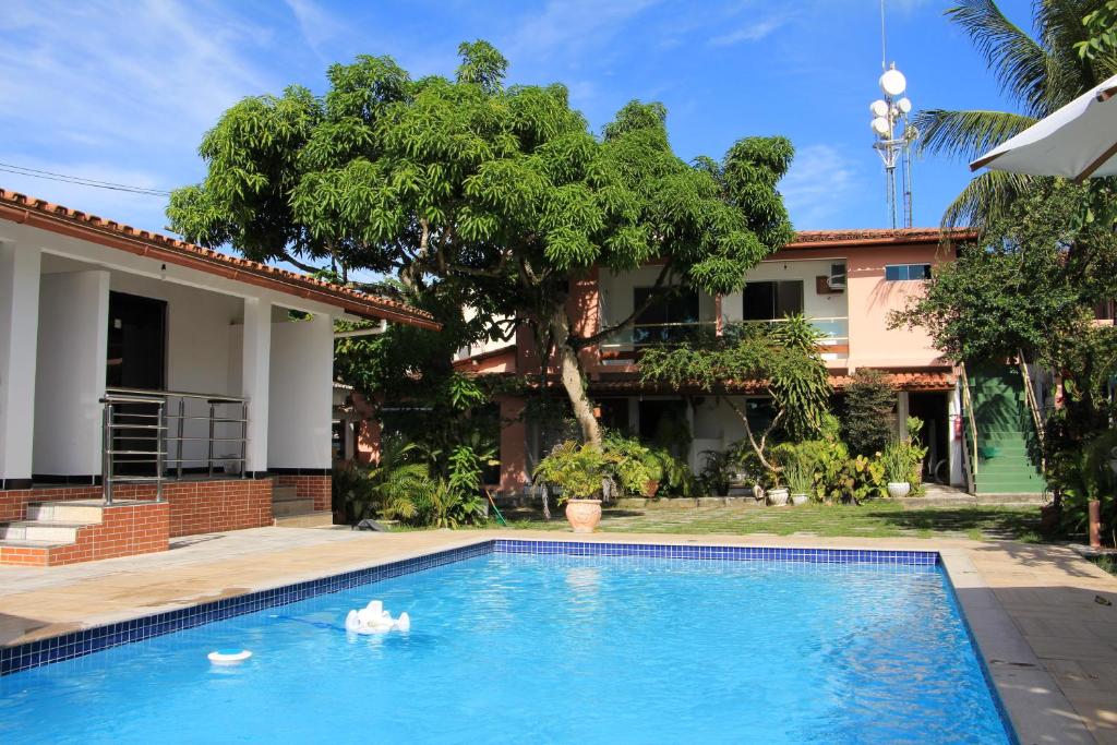 a swimming pool in front of a house at Pousada Manga Rosa- Arraial in Arraial d'Ajuda