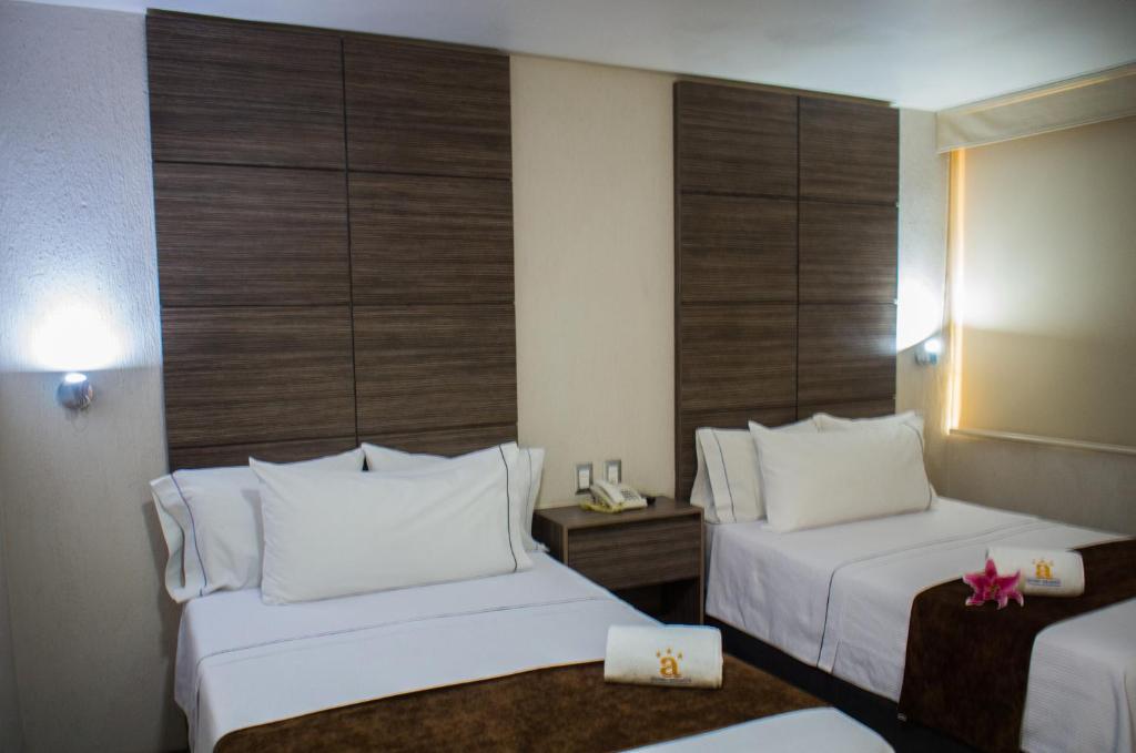 Postel nebo postele na pokoji v ubytování Hotel Expo Abastos