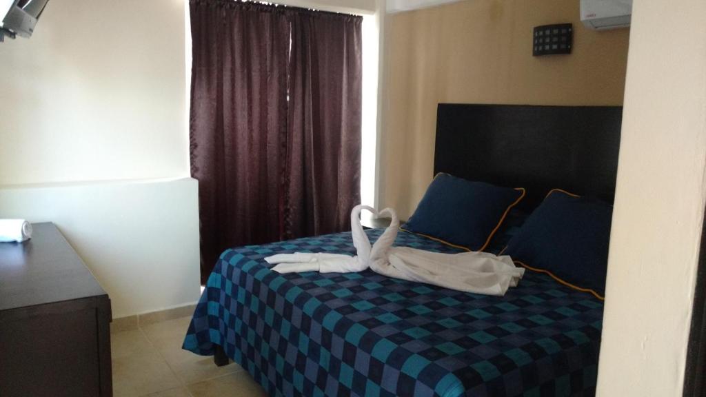 Postel nebo postele na pokoji v ubytování Hotel Puerto Inn