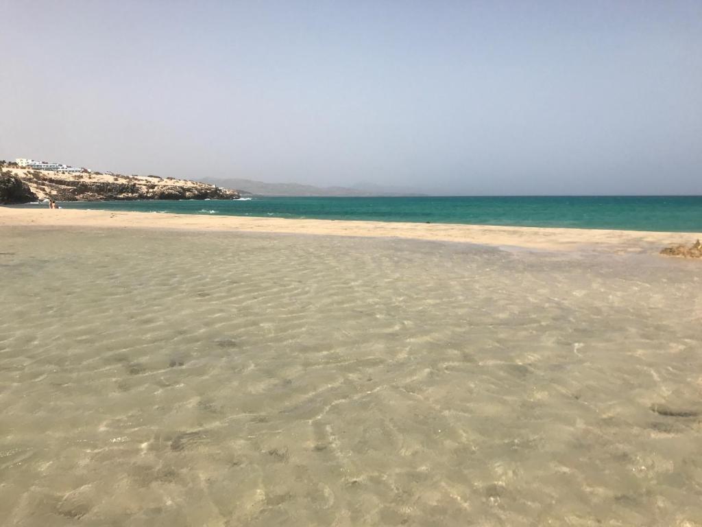 a sandy beach with the ocean in the background at Residencial Playa Paraiso in Costa Calma