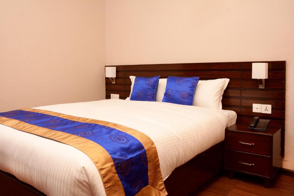 Postel nebo postele na pokoji v ubytování Hotel Mudita