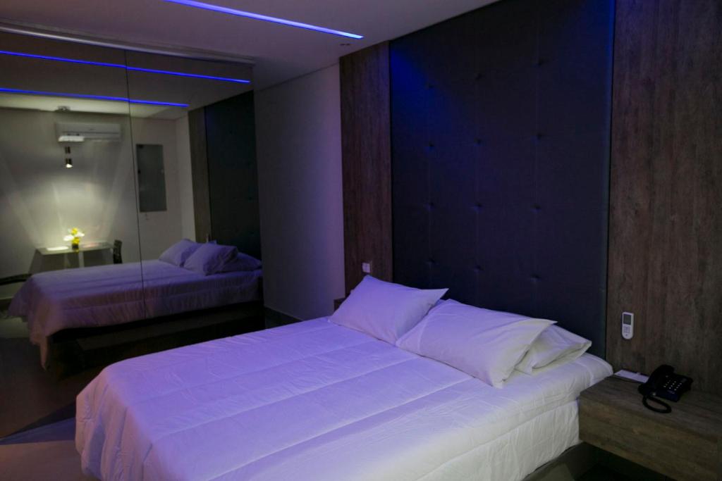 Postel nebo postele na pokoji v ubytování Hauss Excellence Motel