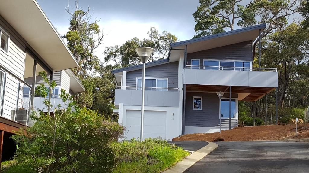 a house with a garage and a driveway at Cape Villas in Dunsborough