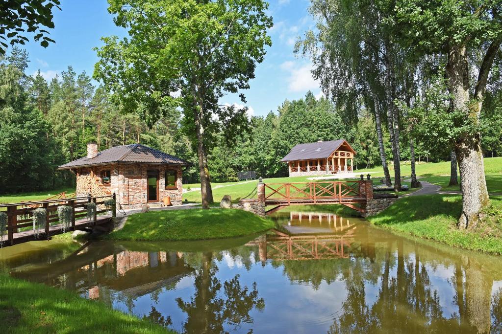 a bridge over a pond with a gazebo at Auksinis Ąžuolas in Avižieniai