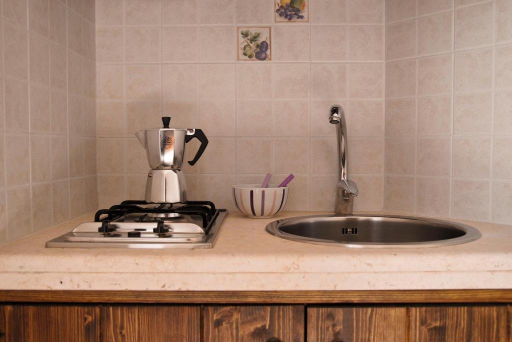 a kitchen counter with a sink and a mixer at Masseria Valente in Ostuni