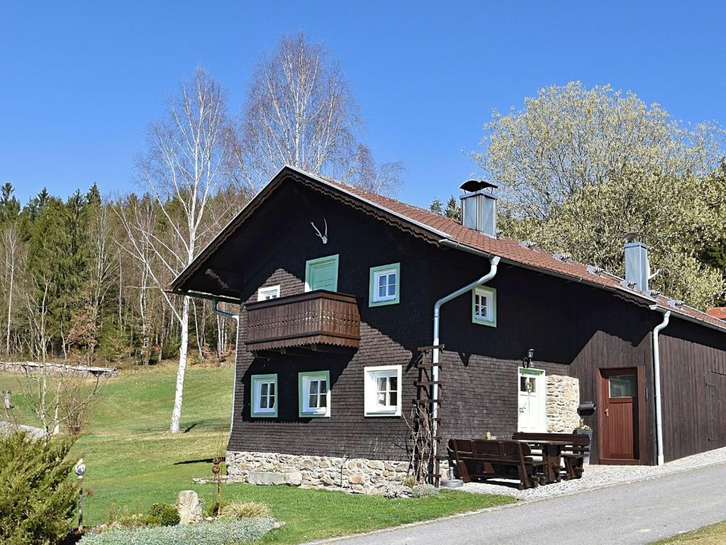 a brown house with a black roof at Holiday home in Rattersberg Bavaria with terrace in Viechtach